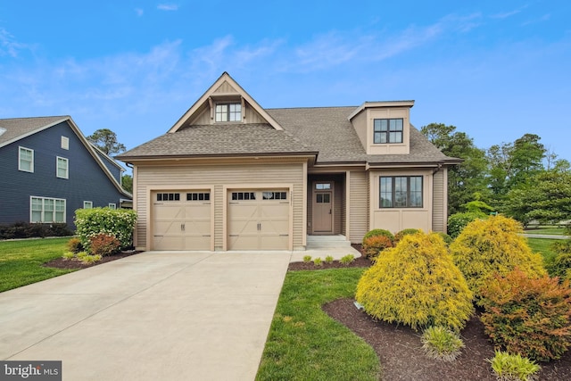view of front of house with a garage, concrete driveway, a shingled roof, and a front yard