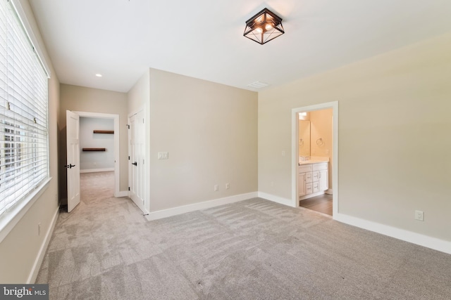 empty room featuring light carpet, baseboards, and recessed lighting
