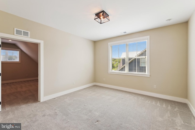 carpeted empty room featuring healthy amount of natural light and baseboards