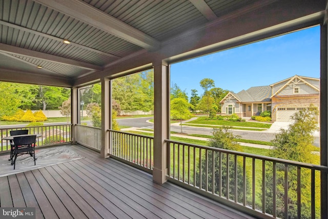 unfurnished sunroom with beam ceiling