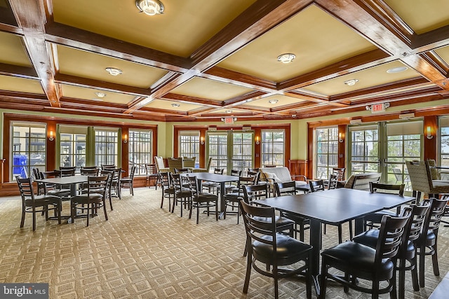 carpeted dining space featuring coffered ceiling, beamed ceiling, and french doors