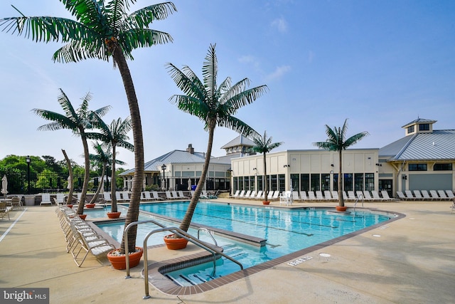 community pool featuring a patio and fence
