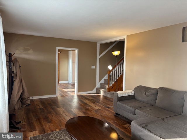 living room with wood finished floors, stairway, and baseboards