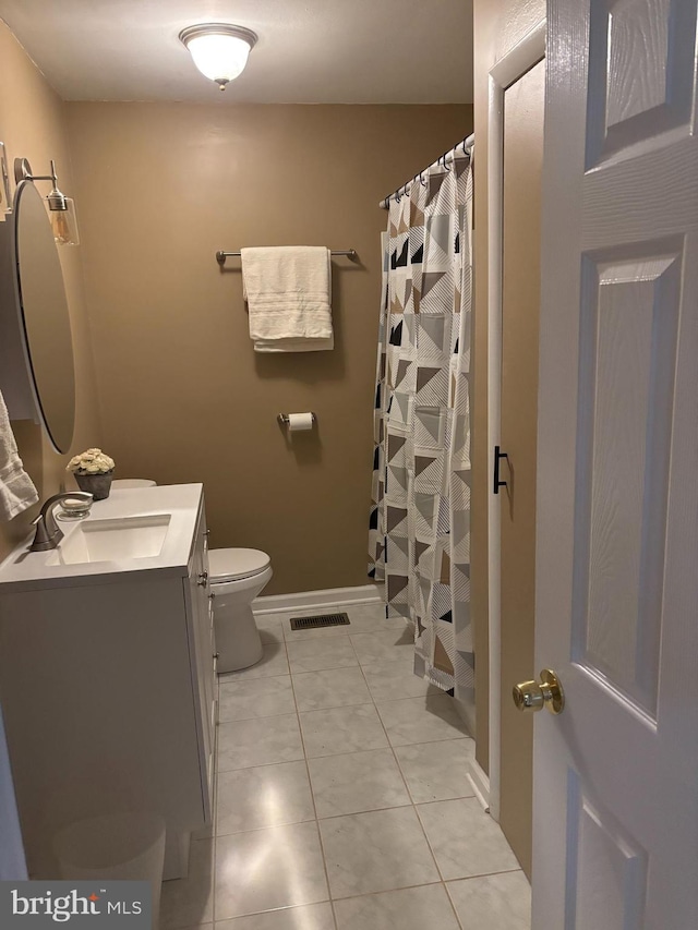 bathroom with toilet, vanity, a shower with shower curtain, and tile patterned floors