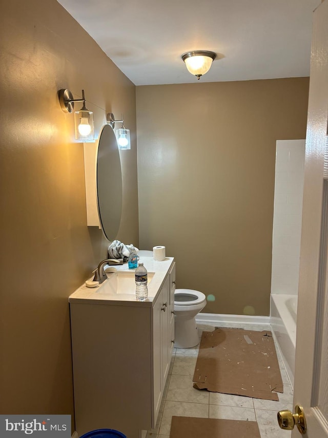 bathroom featuring toilet, vanity, a tub, and tile patterned flooring