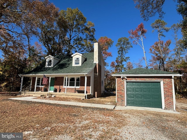 view of front facade with covered porch, brick siding, dirt driveway, a chimney, and an outbuilding