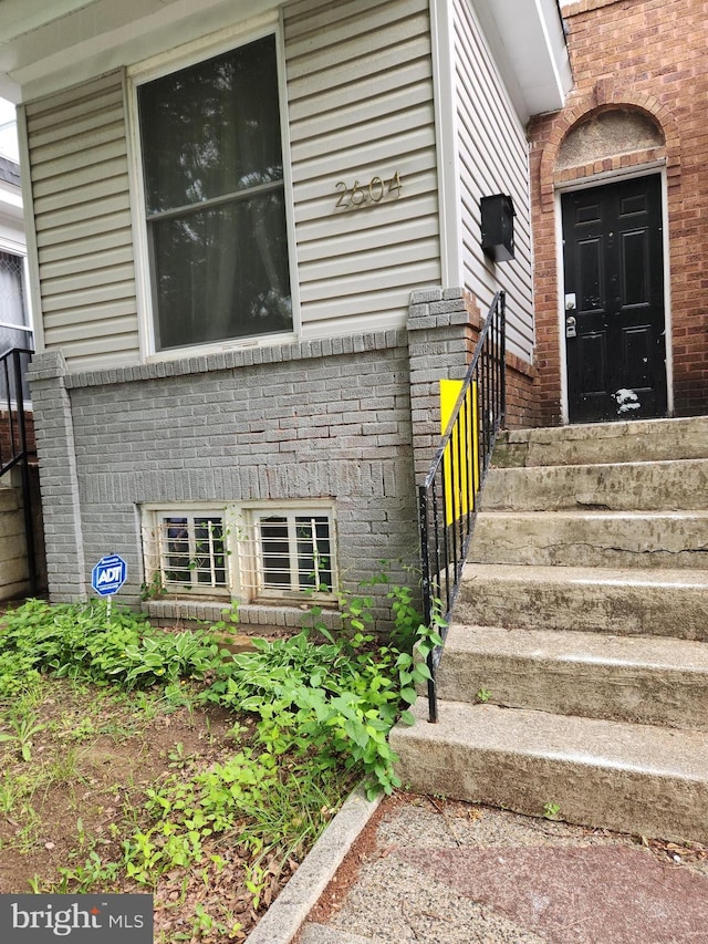 property entrance with brick siding