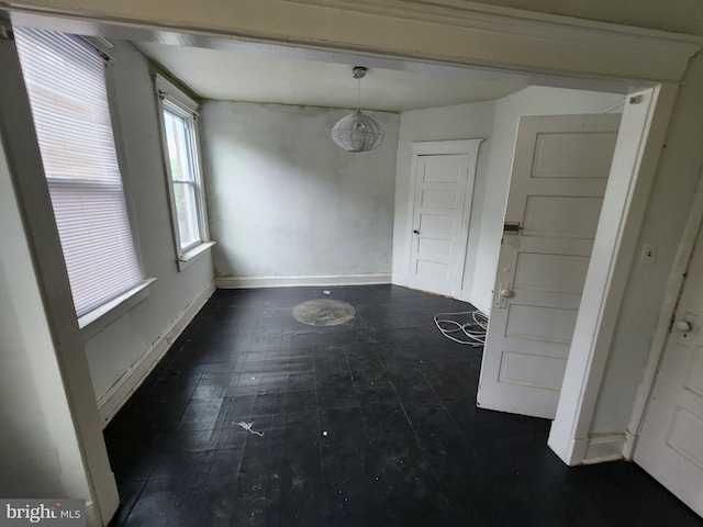 unfurnished dining area featuring baseboards