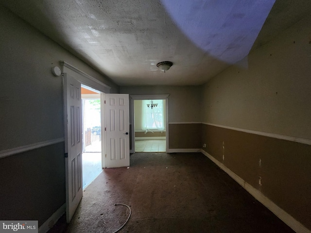 unfurnished room with baseboards
