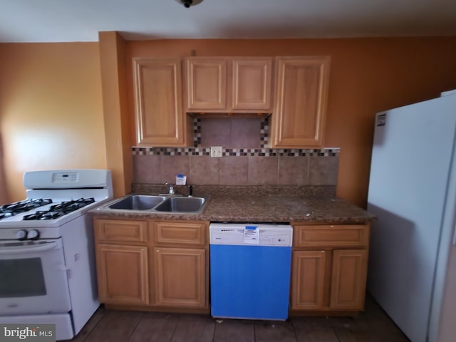kitchen featuring white appliances, a sink, and backsplash