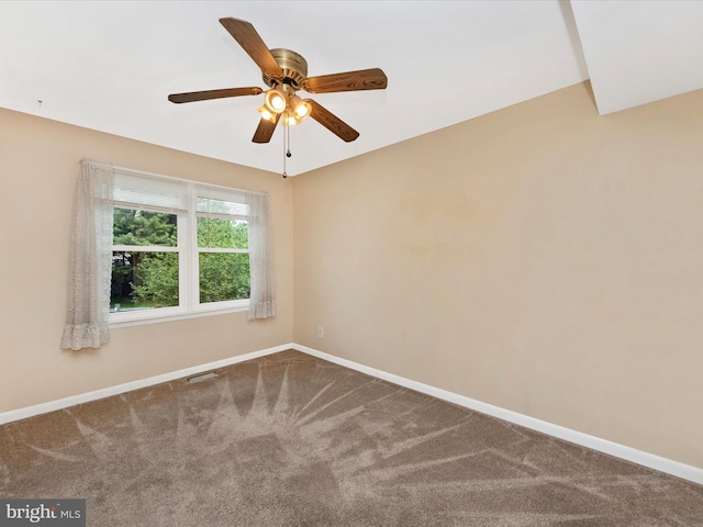 carpeted spare room with baseboards and ceiling fan