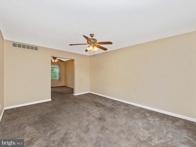 empty room with carpet floors, ceiling fan, and baseboards