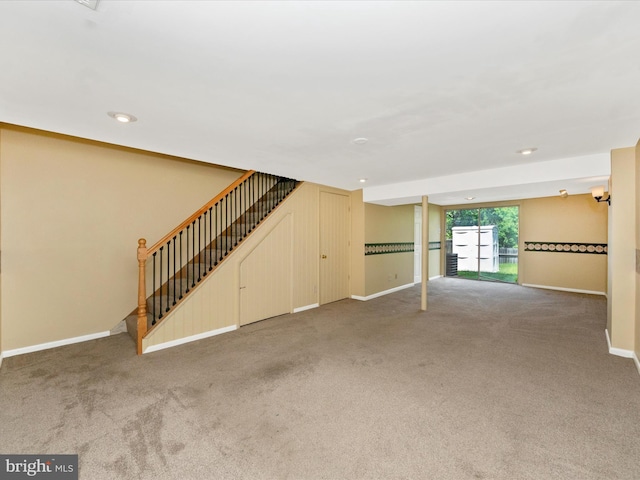 unfurnished living room with carpet flooring, stairway, baseboards, and recessed lighting