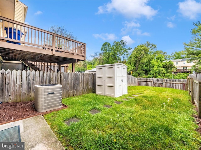view of yard featuring cooling unit, a storage unit, an outbuilding, and a wooden deck