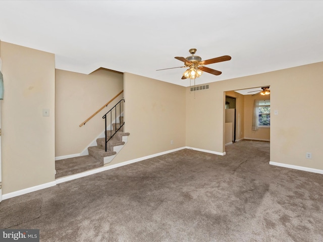 unfurnished living room with a ceiling fan, carpet flooring, stairway, and baseboards