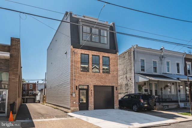 view of front of house featuring concrete driveway, brick siding, and an attached garage