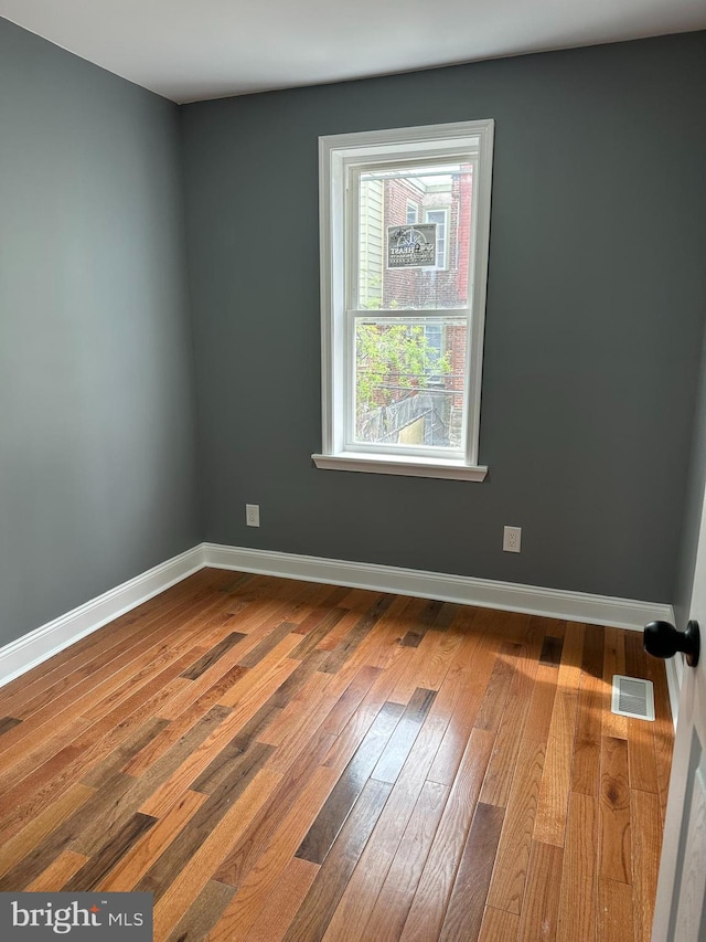 124 E Ruscomb St, Philadelphia, PA 19120 - empty room with dark wood-style flooring and baseboards