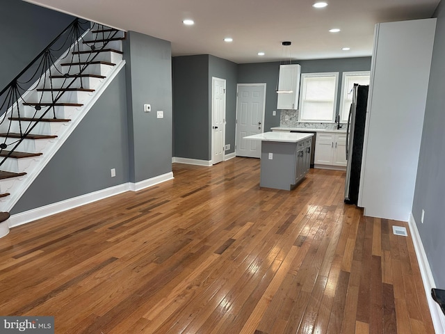 124 E Ruscomb St, Philadelphia, PA 19120 - kitchen featuring freestanding refrigerator, a kitchen island, dark wood-style flooring, baseboards, and light countertops