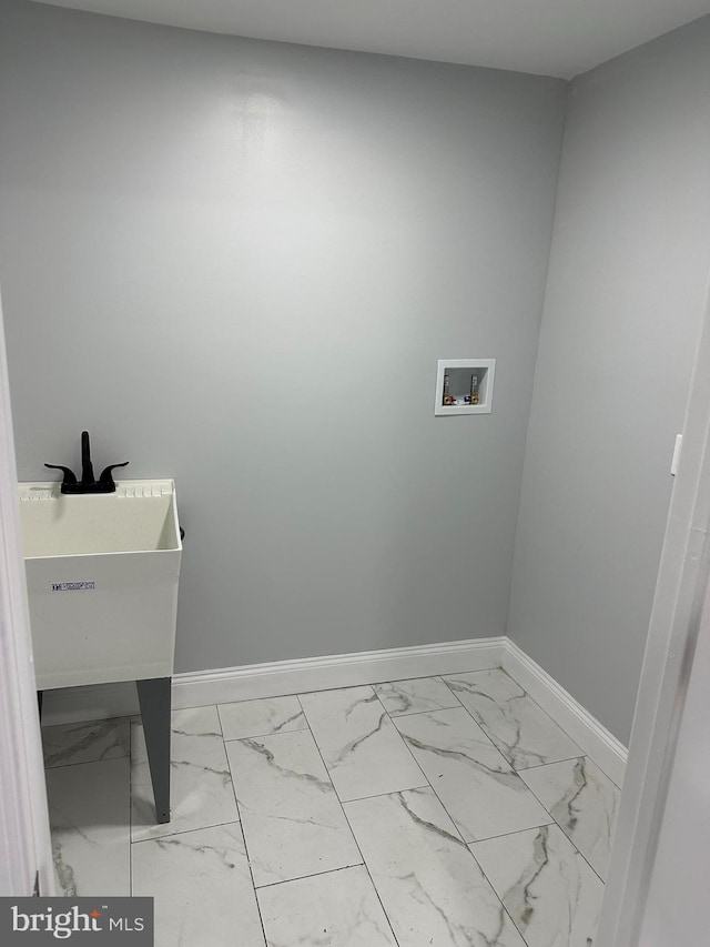 124 E Ruscomb St, Philadelphia, PA 19120 - laundry room featuring washer hookup, baseboards, and light marble finish floors