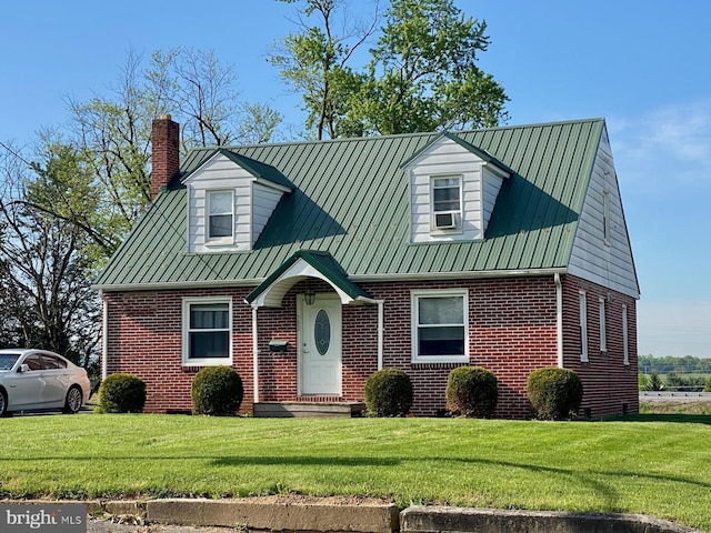 382 W Main St, Fayetteville, PA 17222 - cape cod house featuring brick siding, a chimney, a front yard, and metal roof