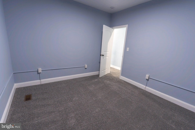 3211 Baker St, Baltimore, MD 21216 - spare room featuring dark carpet and baseboards