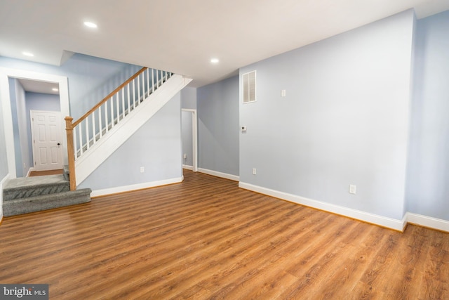 3211 Baker St, Baltimore, MD 21216 - unfurnished living room featuring light wood-type flooring, stairs, baseboards, and recessed lighting