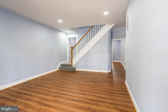 3211 Baker St, Baltimore, MD 21216 - unfurnished living room featuring recessed lighting, stairway, wood finished floors, and baseboards