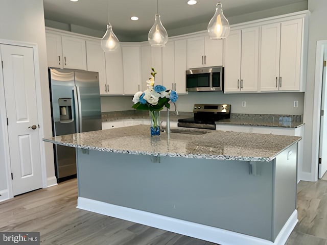 112 Amberfield Ct, Winchester, VA 22602 - kitchen with stainless steel appliances, white cabinets, light wood-style flooring, recessed lighting, and a breakfast bar area
