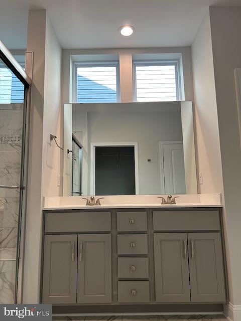 112 Amberfield Ct, Winchester, VA 22602 - bathroom featuring a marble finish shower, double vanity, and healthy amount of natural light