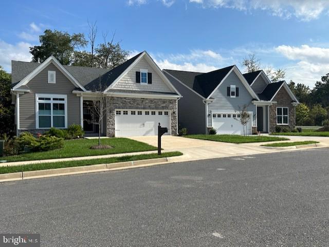 112 Amberfield Ct, Winchester, VA 22602 - craftsman house featuring driveway, stone siding, a front lawn, and a garage