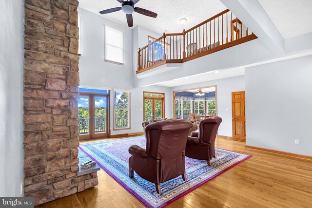 10150 Lapworth Pl, Charlotte Hall, MD 20622 - living area with a ceiling fan, french doors, wood finished floors, baseboards, and a towering ceiling