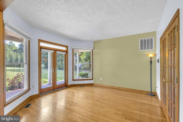 10150 Lapworth Pl, Charlotte Hall, MD 20622 - empty room featuring light wood-style floors, baseboards, and a textured ceiling
