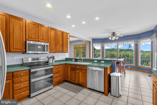 10150 Lapworth Pl, Charlotte Hall, MD 20622 - kitchen with stainless steel appliances, a sink, recessed lighting, a ceiling fan, and brown cabinets