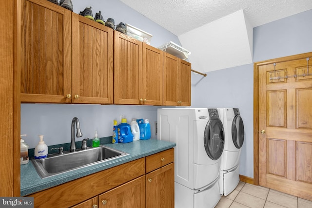 10150 Lapworth Pl, Charlotte Hall, MD 20622 - washroom with washing machine and dryer, cabinet space, light tile patterned flooring, and a textured ceiling