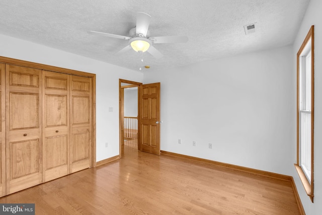 10150 Lapworth Pl, Charlotte Hall, MD 20622 - unfurnished bedroom featuring light wood-style flooring, a textured ceiling, baseboards, a closet, and ceiling fan