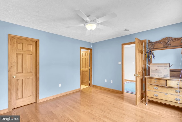 10150 Lapworth Pl, Charlotte Hall, MD 20622 - bedroom with wood finished floors, baseboards, a textured ceiling, and a ceiling fan