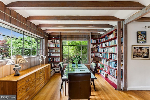 home office with light wood finished floors, beam ceiling, and baseboards