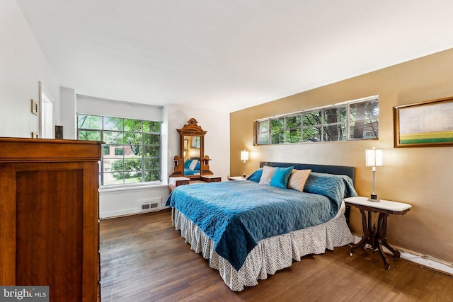 bedroom featuring dark wood finished floors and baseboards