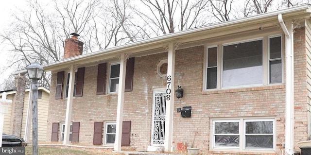 6708 Calmos St, Capitol Heights, MD 20743 - split foyer home with a chimney and brick siding
