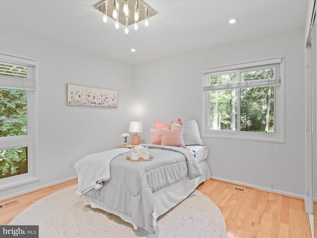 bedroom with wood finished floors and recessed lighting