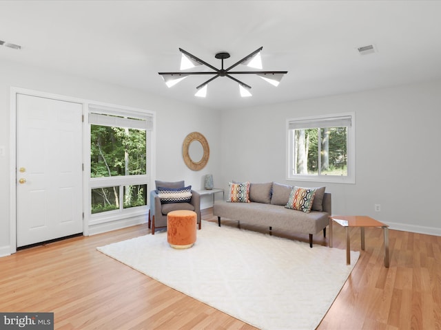 living area with healthy amount of natural light and wood finished floors