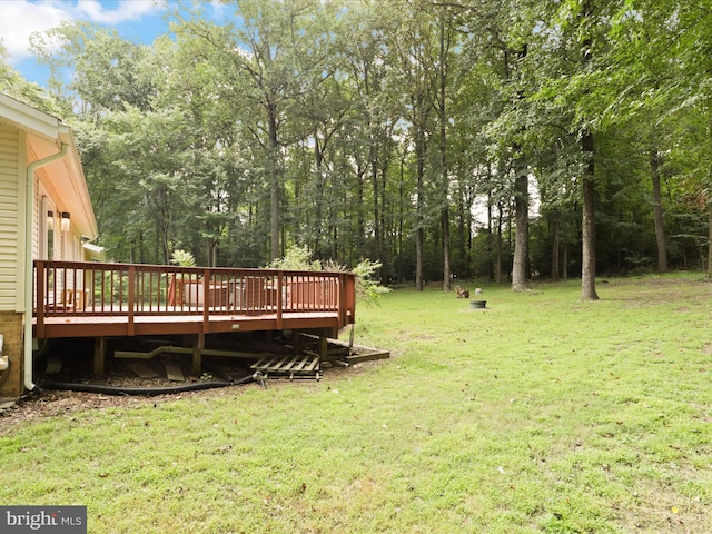 view of green lawn featuring a deck