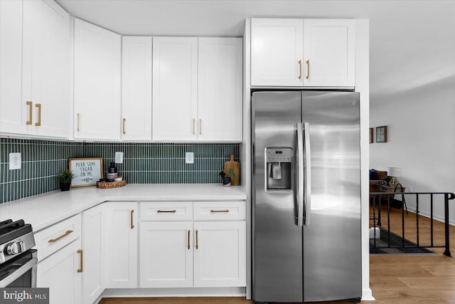 504 Kenora Dr, Millersville, MD 21108 - kitchen featuring stainless steel appliances, white cabinetry, light countertops, backsplash, and light wood-style flooring
