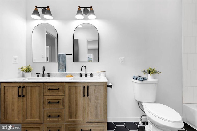 504 Kenora Dr, Millersville, MD 21108 - full bathroom with double vanity, toilet, baseboards, and tile patterned floors