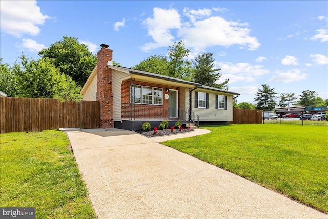 504 Kenora Dr, Millersville, MD 21108 - view of front facade featuring a chimney, concrete driveway, and brick siding