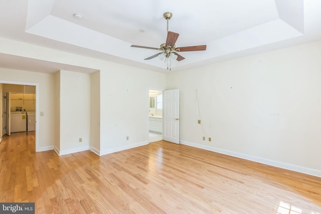 2 Larch Way, Princeton, NJ 08540 - spare room featuring separate washer and dryer, light wood-type flooring, a tray ceiling, and a ceiling fan