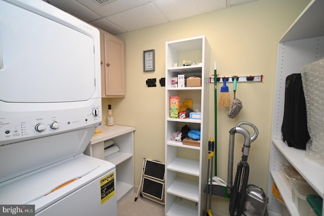 3201 Centennial Sta, Warminster, PA 18974 - washroom featuring stacked washer and clothes dryer, cabinet space, and light tile patterned flooring