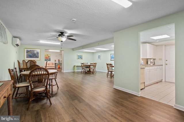 3201 Centennial Sta, Warminster, PA 18974 - dining space with wood finished floors, a wall mounted air conditioner, a ceiling fan, a textured ceiling, and baseboards