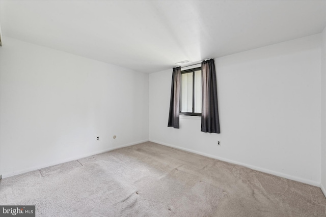 empty room with carpet flooring and baseboards