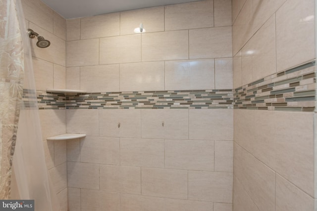 bathroom with tiled shower